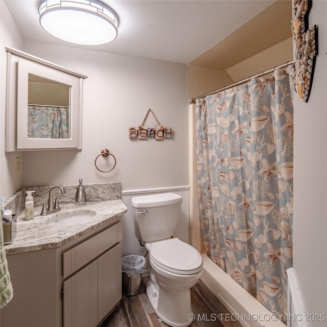 bathroom with toilet, curtained shower, wood finished floors, and vanity