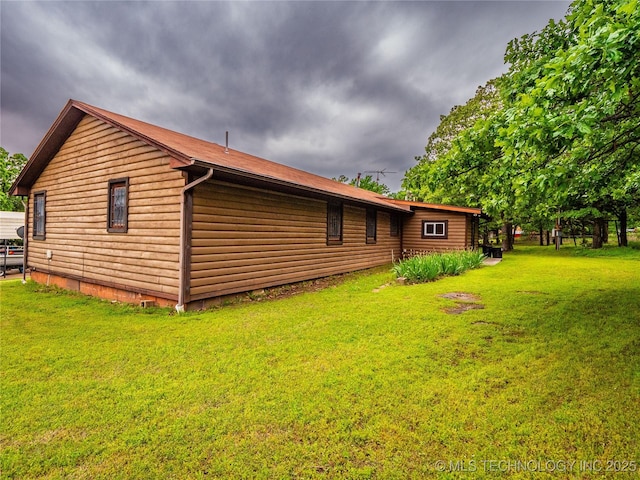 view of side of home with a lawn