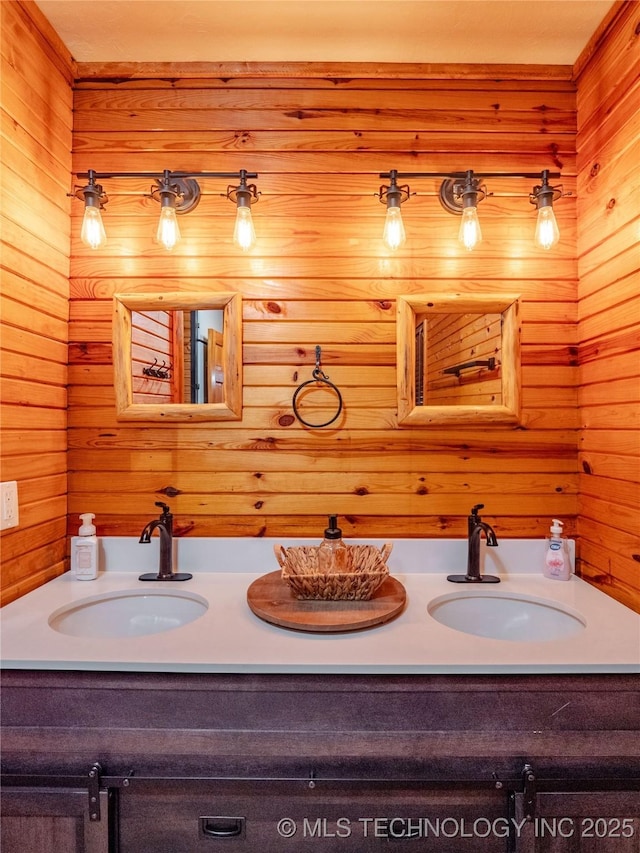 bathroom with double vanity, wood walls, and a sink