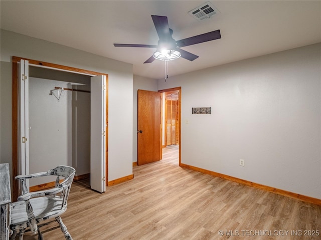 bedroom featuring a closet, baseboards, visible vents, and light wood-type flooring