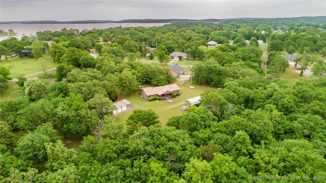 birds eye view of property featuring a view of trees