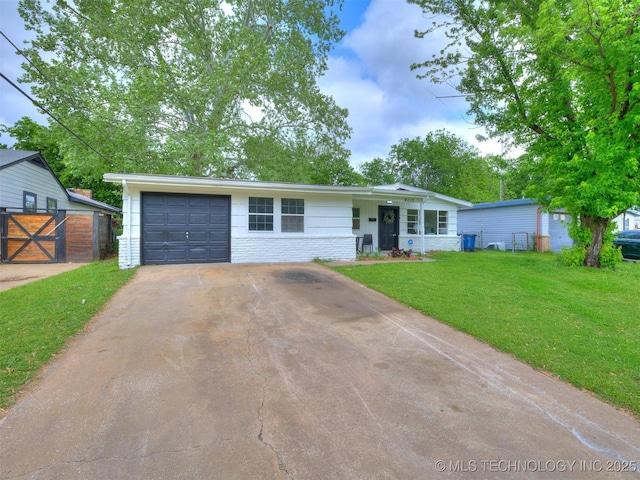 ranch-style house with fence, a front yard, and concrete driveway