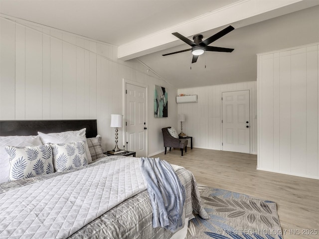 bedroom with vaulted ceiling with beams, a ceiling fan, wood finished floors, and a wall mounted air conditioner