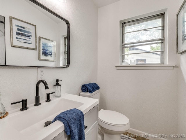 bathroom with toilet and vanity