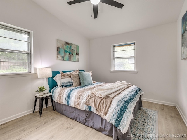 bedroom featuring a ceiling fan, baseboards, wood finished floors, and lofted ceiling