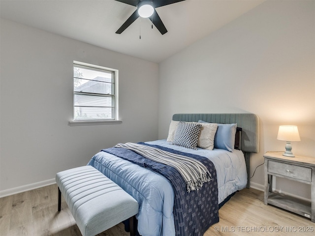 bedroom featuring baseboards, a ceiling fan, and wood finished floors