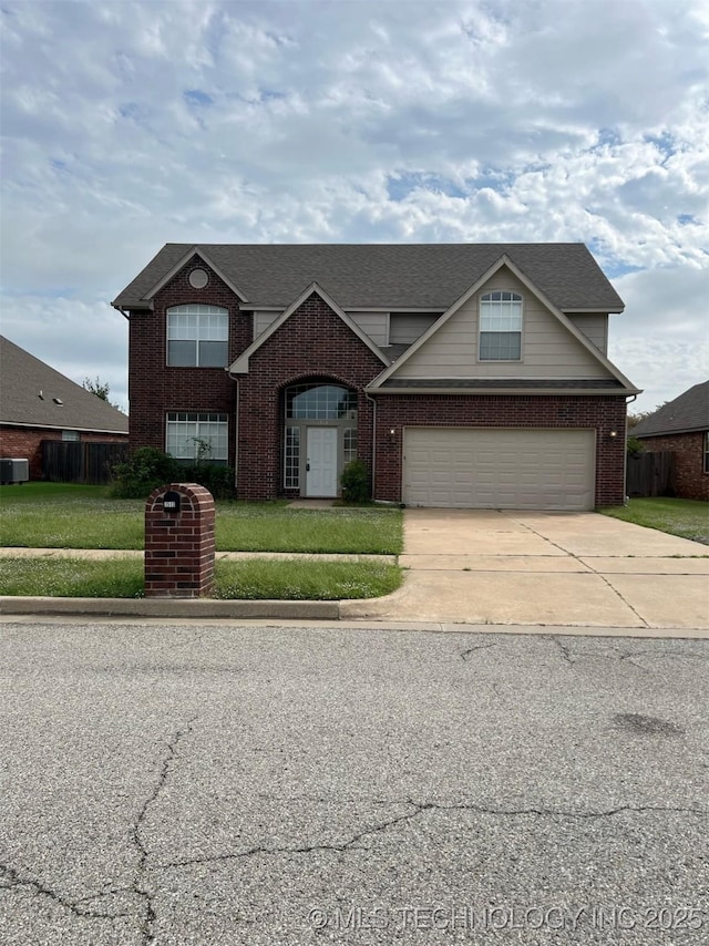 traditional-style home featuring fence, brick siding, a garage, a front yard, and driveway
