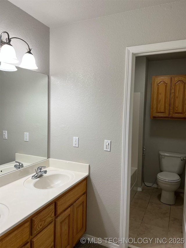 full bath with tile patterned flooring, a sink, double vanity, and toilet