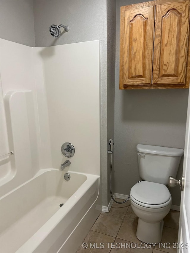 full bath with shower / bathtub combination, tile patterned flooring, baseboards, and toilet