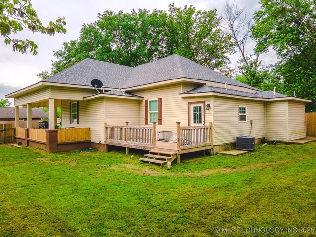 711 W Denton Ave, Sallisaw, OK 74955 - rear view of property with roof with shingles, a wooden deck, central AC unit, fence, and a yard