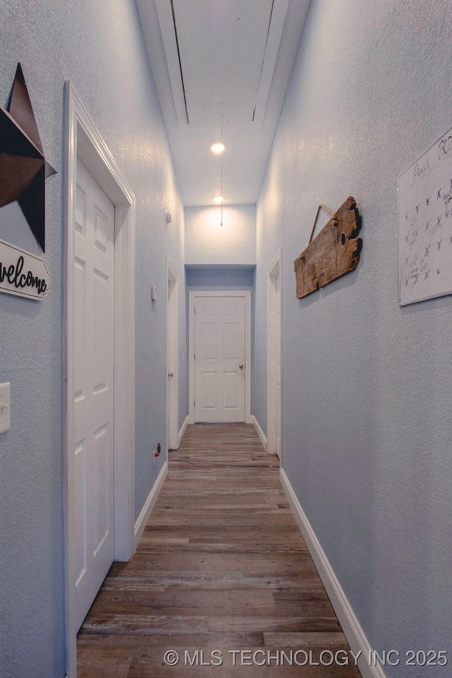 711 W Denton Ave, Sallisaw, OK 74955 - hallway with baseboards, attic access, and wood finished floors