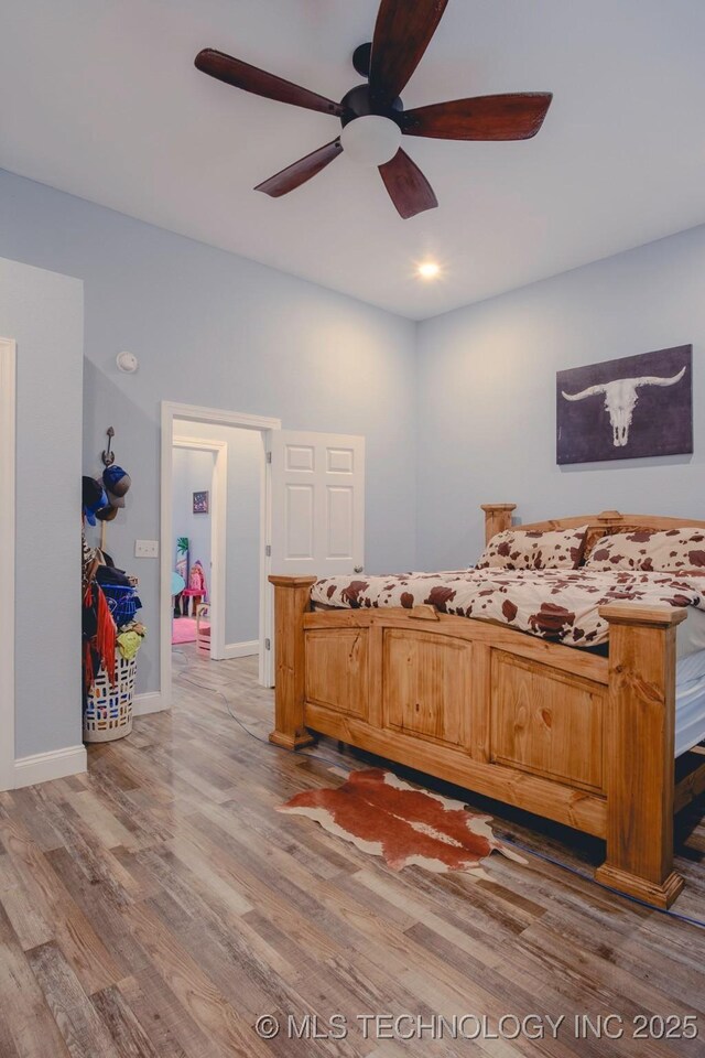 711 W Denton Ave, Sallisaw, OK 74955 - bedroom with baseboards, ceiling fan, and wood finished floors