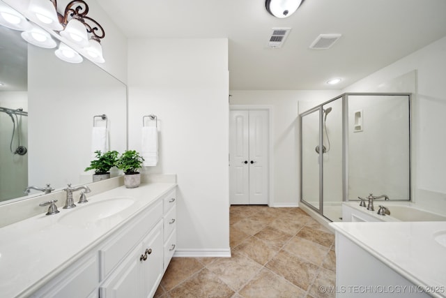full bath featuring a stall shower, two vanities, baseboards, and recessed lighting