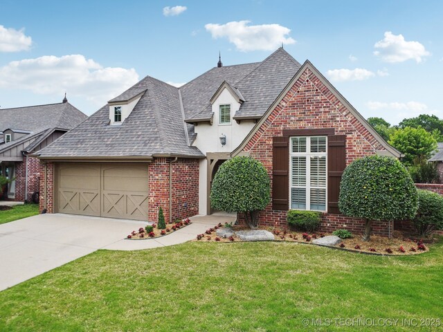 view of front of property featuring brick siding, a garage, concrete driveway, and a front lawn