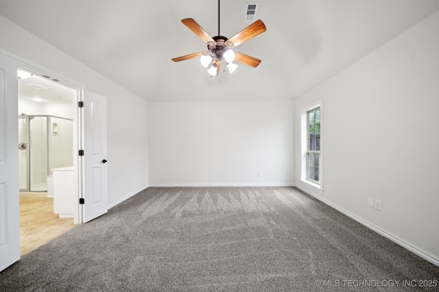 unfurnished room with a ceiling fan, carpet floors, vaulted ceiling, and baseboards
