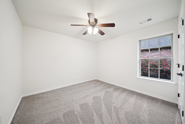 spare room featuring ceiling fan, carpet floors, and baseboards