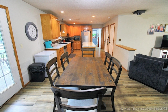 dining space with baseboards, recessed lighting, visible vents, and light wood-type flooring