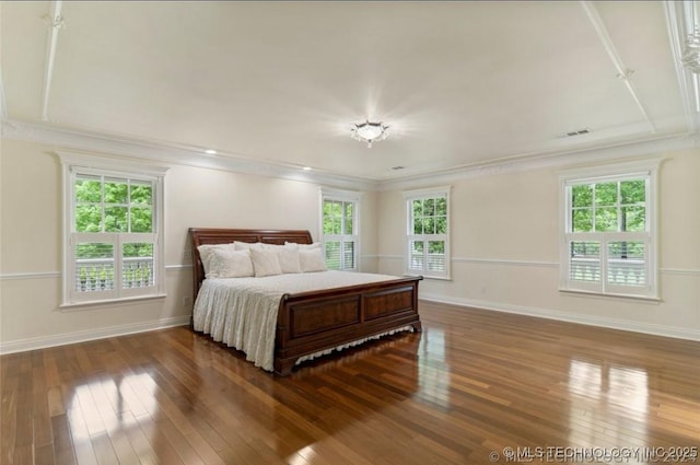 bedroom with wood-type flooring, baseboards, and crown molding
