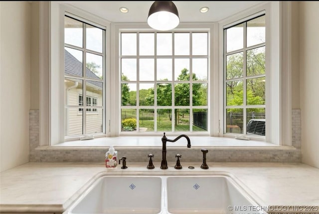 interior details with a sink and light countertops