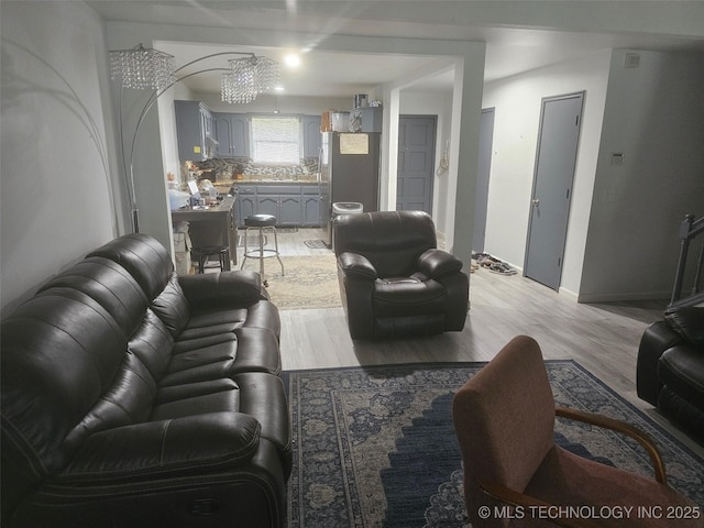 living area with baseboards and light wood finished floors
