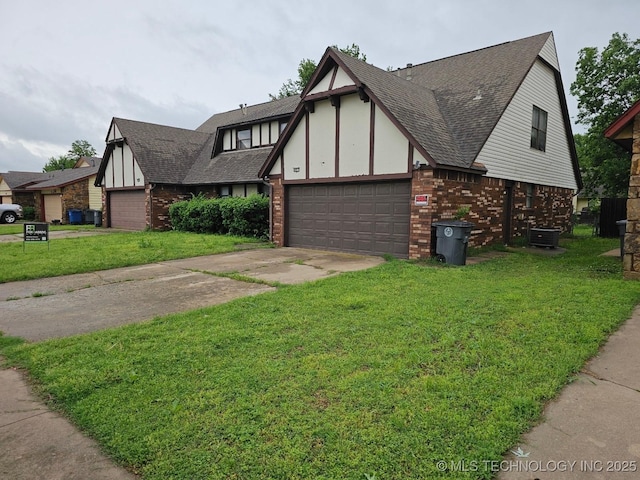 english style home featuring a garage, a front yard, roof with shingles, brick siding, and driveway