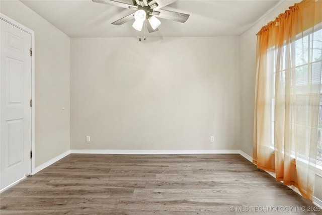 empty room with baseboards, a ceiling fan, and wood finished floors