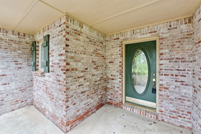 property entrance with brick siding