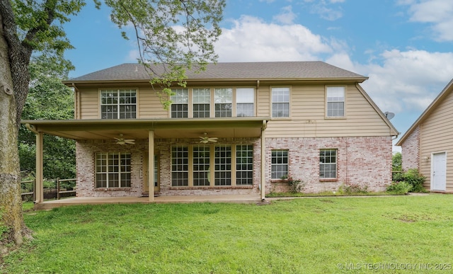 back of property featuring a patio, ceiling fan, a yard, and brick siding