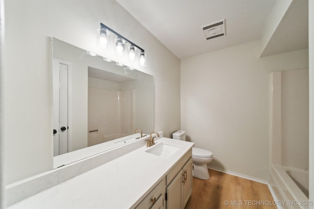 full bathroom featuring vanity, toilet, baseboards, wood finished floors, and visible vents