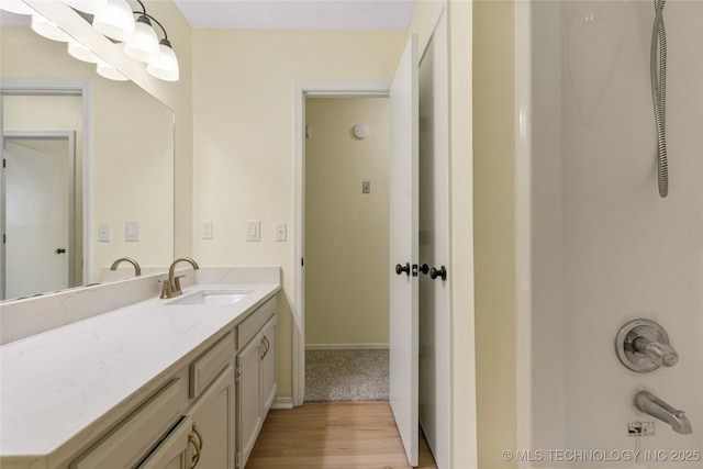 bathroom featuring vanity, baseboards, and wood finished floors