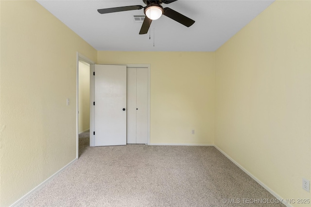 unfurnished bedroom with a closet, carpet flooring, and baseboards