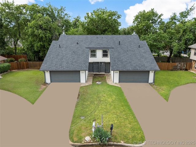 view of front of house with a garage, roof with shingles, fence, and a front yard