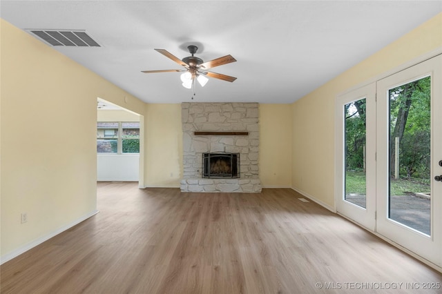 unfurnished living room with baseboards, ceiling fan, light wood-style flooring, and visible vents