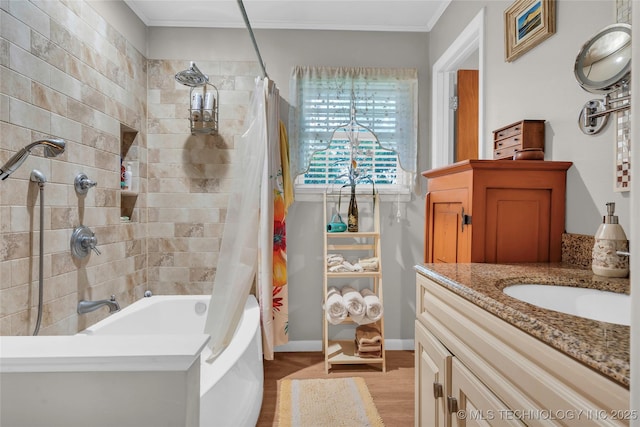 bathroom featuring wood finished floors, vanity, baseboards, shower / tub combo with curtain, and ornamental molding