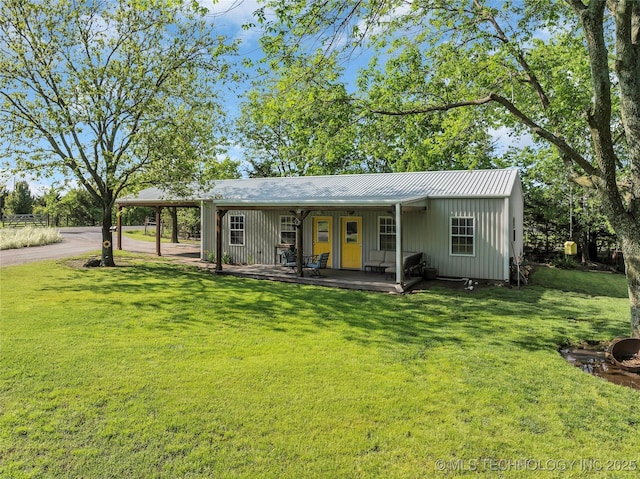 view of front of home featuring a front lawn and metal roof
