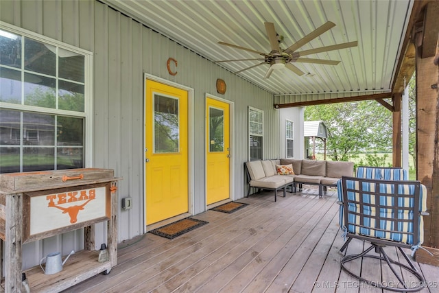 deck with an outdoor living space and ceiling fan