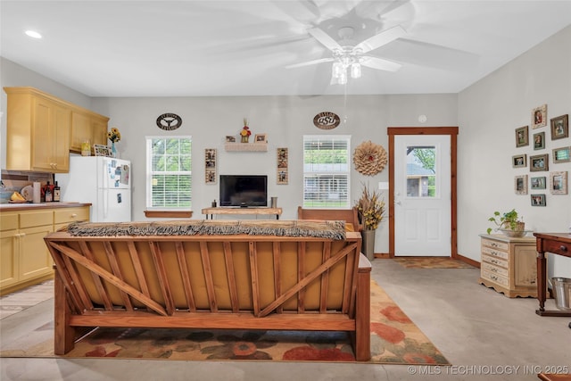living area featuring recessed lighting, a ceiling fan, and a healthy amount of sunlight