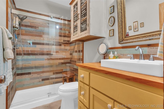 full bath with vanity, decorative backsplash, a stall shower, and toilet