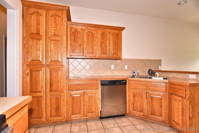 kitchen featuring a sink, dishwasher, tasteful backsplash, and light countertops