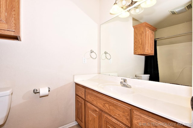 bathroom with toilet, baseboards, visible vents, and vanity