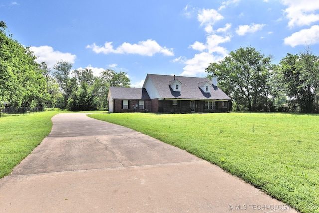 cape cod-style house with driveway and a front lawn