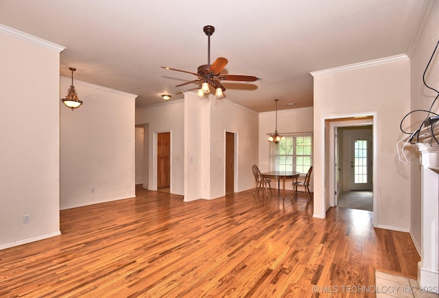 unfurnished living room with baseboards, ornamental molding, light wood-style flooring, and ceiling fan with notable chandelier