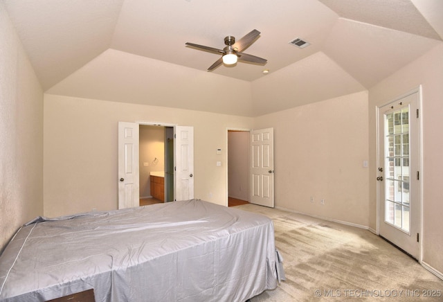 bedroom with visible vents, lofted ceiling, ensuite bath, and light carpet