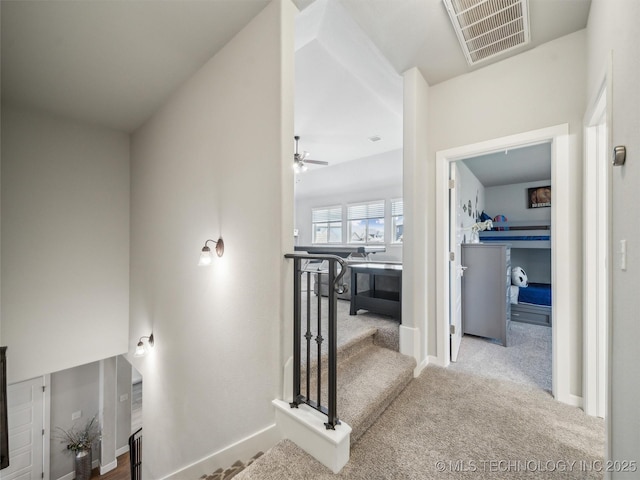hall featuring carpet flooring, baseboards, and visible vents