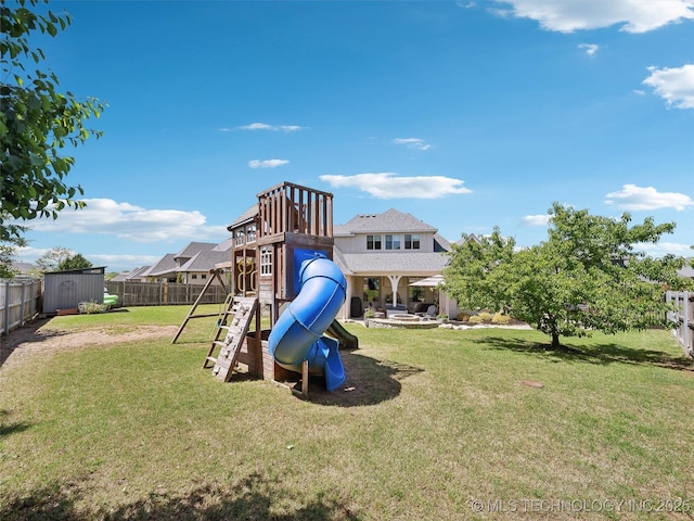 view of jungle gym with a fenced backyard, a storage unit, an outbuilding, and a yard