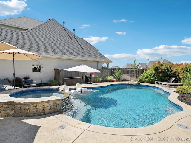 view of pool with a fenced backyard, a pool with connected hot tub, and a patio area