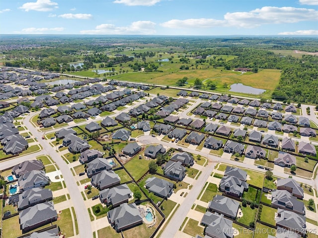 bird's eye view featuring a residential view and a water view