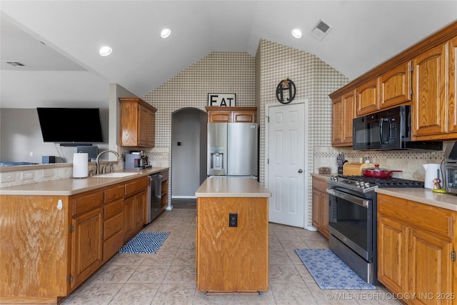 3933 S 199th E Ave, Broken Arrow, OK 74014 - kitchen featuring appliances with stainless steel finishes, a sink, a center island, vaulted ceiling, and visible vents