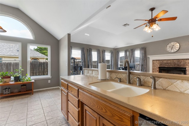 3933 S 199th E Ave, Broken Arrow, OK 74014 - kitchen featuring visible vents, a ceiling fan, lofted ceiling, brown cabinets, and a sink