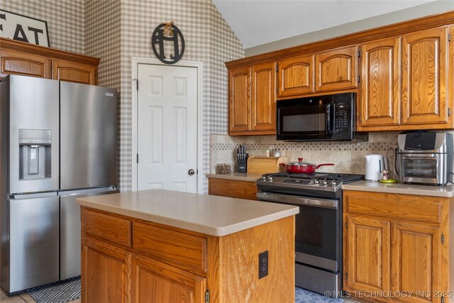3933 S 199th E Ave, Broken Arrow, OK 74014 - kitchen with light countertops, stainless steel appliances, wallpapered walls, and a kitchen island